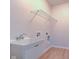 White utility sink in laundry room with wood floors at 9182 Mulligan Ct, Elwood, IN 46036
