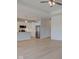 Open-concept living space with light wood floors and white cabinets in the kitchen at 9182 Mulligan Ct, Elwood, IN 46036