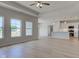 Open-concept living space with light wood floors connects living room and kitchen at 9182 Mulligan Ct, Elwood, IN 46036