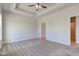 Spacious main bedroom featuring neutral carpeting and a trey ceiling with a ceiling fan at 9182 Mulligan Ct, Elwood, IN 46036