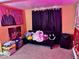 Finished basement area featuring a futon couch and decor at 921 W Carson St, Muncie, IN 47303