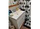 Bathroom sink with patterned floor tiles and a smiley face shower curtain at 921 W Carson St, Muncie, IN 47303
