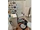 Bathroom with a smiley face shower curtain and patterned floor tiles at 921 W Carson St, Muncie, IN 47303