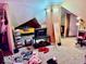 Unique bedroom with sloped ceilings, closet, desk, and personal items at 921 W Carson St, Muncie, IN 47303