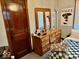 Bedroom with a wooden dresser, decorative mirror, and a wooden door at 921 W Carson St, Muncie, IN 47303