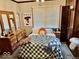 Bedroom with a decorative vogue poster and a plaid blanket at 921 W Carson St, Muncie, IN 47303