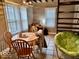 Bright dining area with a table and chairs, natural light, and unique seating at 921 W Carson St, Muncie, IN 47303