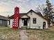 Charming one story home featuring a bold chimney design and dormant lawn at 921 W Carson St, Muncie, IN 47303