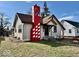 Charming one story home featuring a bold chimney design and freshly cut lawn at 921 W Carson St, Muncie, IN 47303