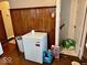 Hallway with a deep freezer and wooden paneling at 921 W Carson St, Muncie, IN 47303