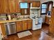 Traditional kitchen with stainless steel dishwasher and wooden cabinetry at 921 W Carson St, Muncie, IN 47303