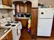 Functional kitchen with vintage cabinets, white appliances, and a gas range at 921 W Carson St, Muncie, IN 47303