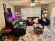 Cozy living room with sofas, fireplace, large rug, and built-in shelving at 921 W Carson St, Muncie, IN 47303