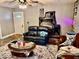 Well-lit living room featuring a sofa, decorative rug, and vintage stone fireplace at 921 W Carson St, Muncie, IN 47303