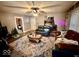 Inviting living room with a fireplace, ceiling fan, and a large decorative rug at 921 W Carson St, Muncie, IN 47303
