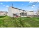 Expansive backyard with patio, screened porch, and lush green lawn at 10221 Tournon Dr, Fishers, IN 46037