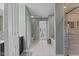 A bathroom with a white tiled floor that leads to a tub and shower at 10221 Tournon Dr, Fishers, IN 46037