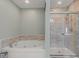 Relaxing bathroom with a jacuzzi tub and glass shower enclosure at 10221 Tournon Dr, Fishers, IN 46037