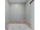Bright bathroom with a jacuzzi tub and tiled walls at 10221 Tournon Dr, Fishers, IN 46037