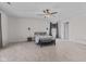 Spacious bedroom features neutral carpet, ceiling fan, ample lighting, and an inviting queen bed at 10221 Tournon Dr, Fishers, IN 46037