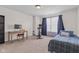 Bright bedroom with a bed, desk, Peloton bike, and natural light streaming in, creating a calming atmosphere at 10221 Tournon Dr, Fishers, IN 46037