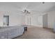 Bright bedroom features neutral walls, ceiling fan, carpet, and a queen bed at 10221 Tournon Dr, Fishers, IN 46037
