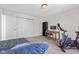 Comfortable bedroom featuring a bed, desk, and workout bike, ideal for both rest and exercise at 10221 Tournon Dr, Fishers, IN 46037