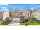 Charming two-story brick home with manicured lawn and two-car garage at 10221 Tournon Dr, Fishers, IN 46037