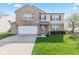 Inviting two-story home with a well-manicured lawn, attached garage, and brick facade, perfect for curb appeal at 10221 Tournon Dr, Fishers, IN 46037