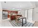 Open kitchen and dining area with stainless steel appliances and cherry cabinets at 10221 Tournon Dr, Fishers, IN 46037
