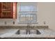 Kitchen sink with granite countertops and stainless steel hardware at 10221 Tournon Dr, Fishers, IN 46037