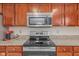 The kitchen features modern stainless steel appliances and custom cabinetry at 10221 Tournon Dr, Fishers, IN 46037