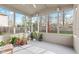 Inviting screened porch filled with plants and offering backyard views of playset at 10221 Tournon Dr, Fishers, IN 46037