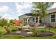Inviting backyard featuring a patio with dining set, a landscaped yard, and a privacy fence at 1024 Cyprian Way, Lebanon, IN 46052