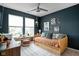 The bedroom is well-lit with large windows, a ceiling fan, and trendy decor at 1024 Cyprian Way, Lebanon, IN 46052