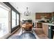 The dining room features a modern chandelier, dark accent wall, and open access to the kitchen at 1024 Cyprian Way, Lebanon, IN 46052