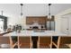 Open kitchen with island, bar seating, stainless steel appliances, and modern pendant lighting at 1024 Cyprian Way, Lebanon, IN 46052