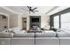 Cozy living room features a large sectional sofa, fireplace, and modern ceiling fan at 1024 Cyprian Way, Lebanon, IN 46052