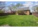 A fully fenced backyard features a green lawn, providing a private outdoor space at 1025 E 60Th St, Indianapolis, IN 46220