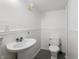 Basement bathroom featuring a pedestal sink, toilet and wainscoting at 1025 E 60Th St, Indianapolis, IN 46220