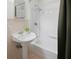 Quaint bathroom features a pedestal sink, bathtub, shower and classic tile at 1025 E 60Th St, Indianapolis, IN 46220