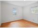 This is a sunny bedroom with two windows and beautiful hardwood floors at 1025 E 60Th St, Indianapolis, IN 46220