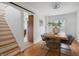 Elegant dining room with a wooden table, hardwood floors, and natural light, perfect for gatherings and meals at 1025 E 60Th St, Indianapolis, IN 46220