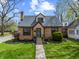 Charming brick home with a manicured lawn, stone walkway, and classic architectural details at 1025 E 60Th St, Indianapolis, IN 46220