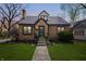 Charming brick home featuring a well-manicured lawn, complemented by elegant landscaping and a welcoming entrance at 1025 E 60Th St, Indianapolis, IN 46220