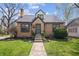 Charming brick home with a manicured lawn, stone walkway, and classic architectural details at 1025 E 60Th St, Indianapolis, IN 46220
