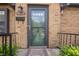 Inviting front entrance with a glass storm door, showcasing a welcoming 'Home Sweet Home' door mat at 1025 E 60Th St, Indianapolis, IN 46220