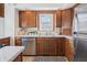Functional kitchen featuring wooden cabinets, stainless steel appliances, and ample counter space for meal preparation at 1025 E 60Th St, Indianapolis, IN 46220