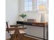 Bright home office with wooden desk and chair next to a window overlooking the outdoors at 1025 E 60Th St, Indianapolis, IN 46220