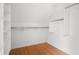 Walk-in closet featuring hardwood floors, white shelving, and ample storage space at 1025 E 60Th St, Indianapolis, IN 46220